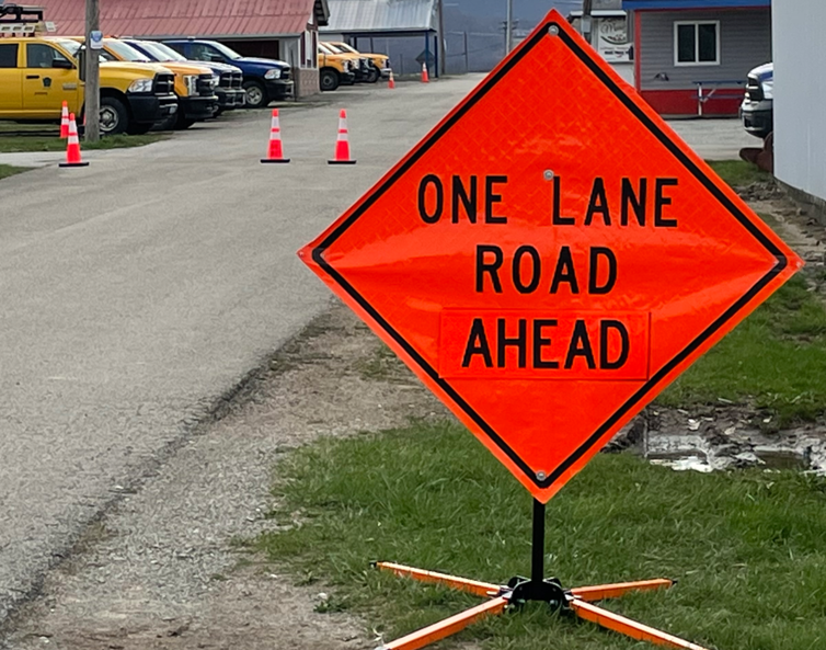An image of a temporary roadwork sign that reads One Lade Road Ahead